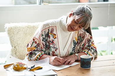 Woman sat at a table writing